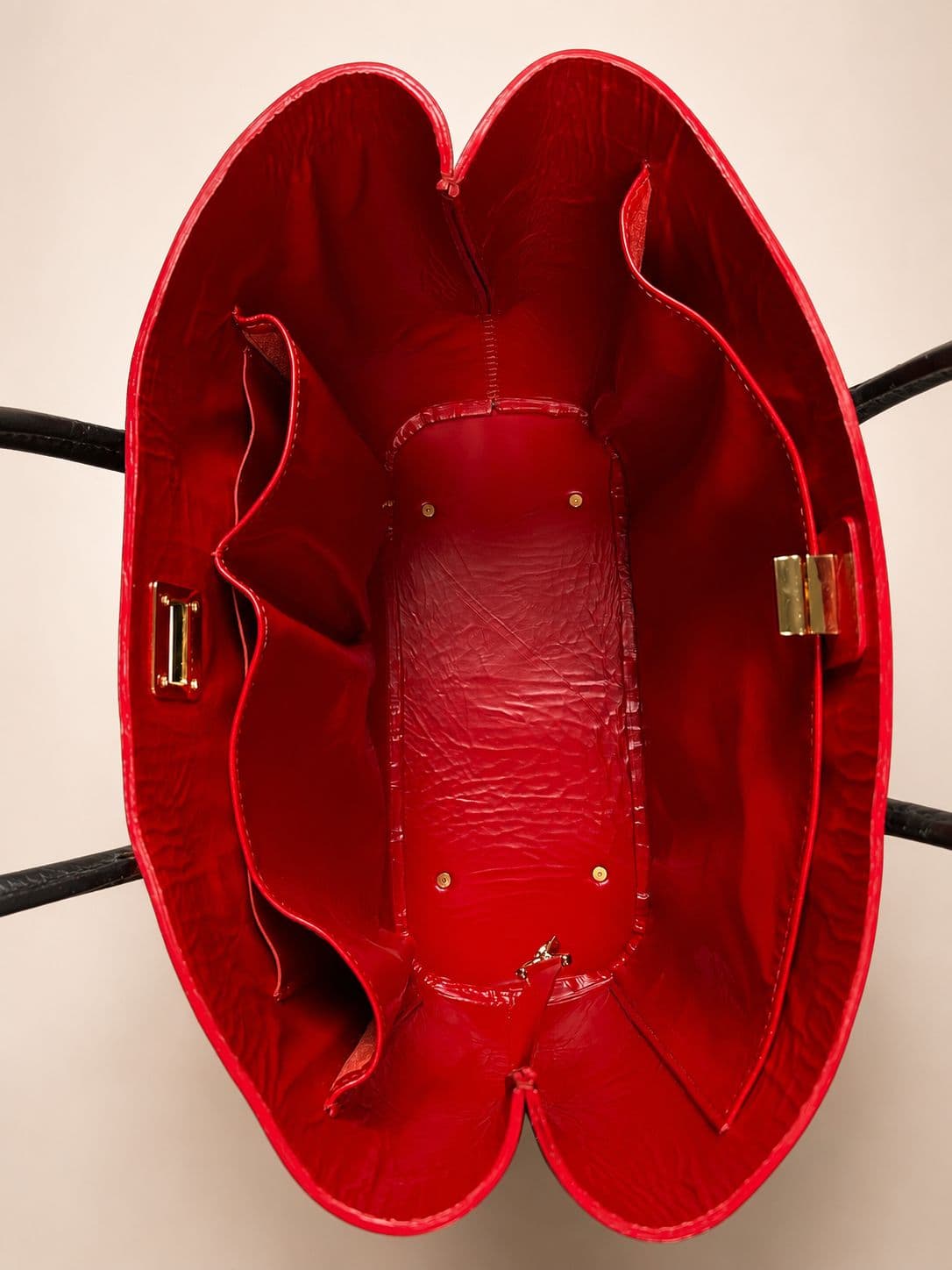 Gichiru Lynn Bag top open view showing the oxblood leather interior compartments and gold hardware
